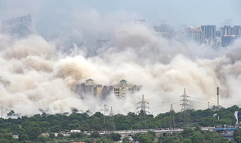 Pulverized concrete dust covers the neighbourhood after demolition of Supertech's twin towers in Noida, Sunday, Aug. 28, 2022. (Photo | PTI)