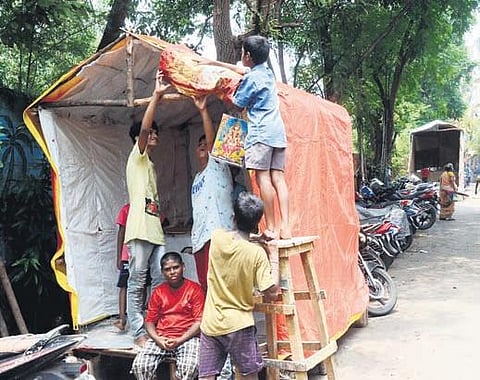 Students preparing Ganesh pandals in Vizag on Sunday. (Photo | G Satyanarayana, EPS)