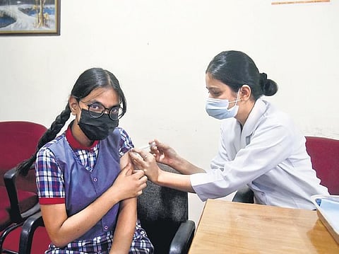 A health worker administers Covid vaccine to a student at RML Hospital | express