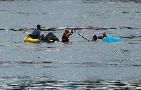 Volunteers of civil defence are trying to pull out their fiber boat that drowned in the Periyar river on Tuesday morning.(Photo | TP Sooraj, EPS)
