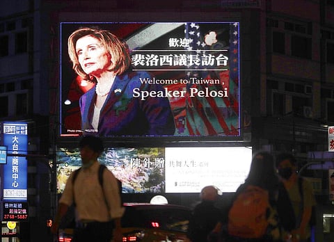 People walk past a billboard welcoming U.S. House Speaker Nancy Pelosi, in Taipei, Taiwan, Tuesday, Aug 2, 2022. (Photo | AP)
