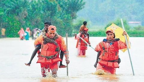 People are seen shifted to a relief center from the flood-affected areas in Manuguru on Sunday