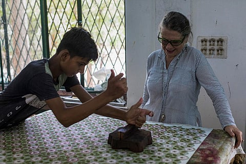 Indian naturalized textile designer Brigitte Singh (R) watches as a worker uses the hand block printing technique on a cotton fabric at her workshop in in Amber, Rajasthan. (Photo | AFP)