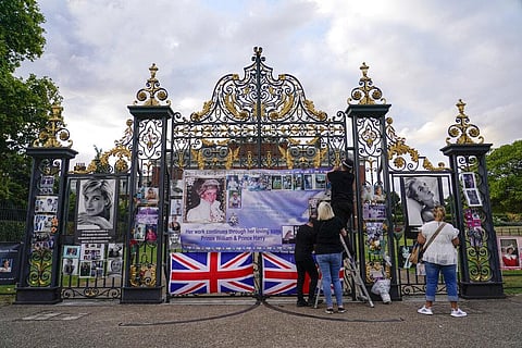 People look at portraits of Princess Diana displayed outside the gates of Kensington Palace, in London, Monday, Aug. 29, 2022. (Photo | AP)