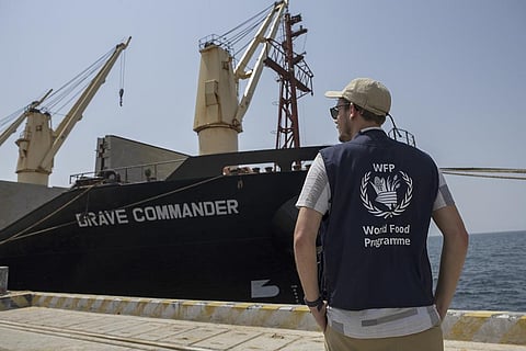A member of the World Food Programme (WFP) stands on the dock next to the Brave Commander bulk carrier ship after it arrived in the port of Djibouti city, Djibouti Tuesday, Aug. 30, 2022. (Photo | AP)