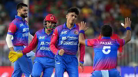 Afghanistan's Mujeeb-ur-Rahman celebrates with teammates after taking the wicket of Bangladesh's Mohammad Naim during the T20 Asia Cup cricket match. 