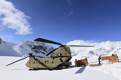 Soldiers and National Park Service personnel offload equipment and supplies from a U.S. Army CH-47 Chinook helicopter on Kahiltna Glacier. (File Photo | AP)