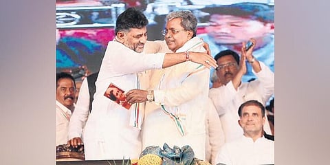 KPCC chief DK Shivakumar and former chief minister Siddaramaiah embrace each other in the presence of Congress MP Rahul Gandhi, at Siddaramaiah’s 75th birthday celebrations. (Photo | Express)