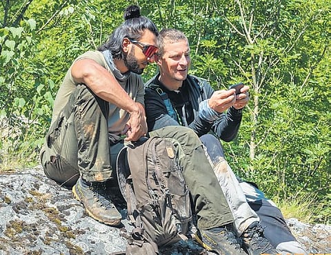 (L-R) Ranveer Singh and Bear Grylls in a still from the show