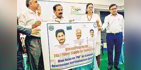 Special Chief Secretary (Energy) K Vijayanand releases a poster at a workshop on the PAT Scheme in Vijayawada on Wednesday. (Photp | Prasant Madugula, EPS)