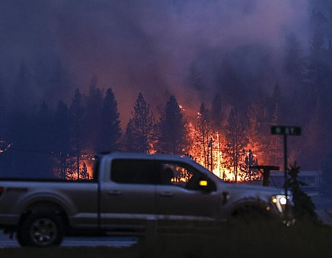 Flames from the Elmo Fire burn around Dayton, Mont., on the western shore of Flathead Lake. (Photo | AP)
