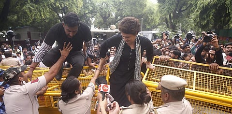 Congress leader Priyanka Gandhi Vadra crossed the police barricades put up on the road outside the party headquarters and squatted on the road. (Photo | EPS)
