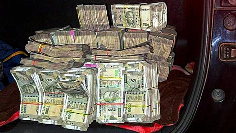 Huge amount of cash which was found in a vehicle in which three Jharkhand Congress MLAs Irfan Ansari, Rajesh Kachhap and Naman Viksal Kongadi, were traveling, at Ranihati. (Photo | PTI)