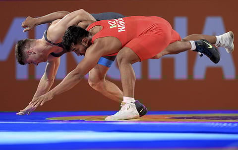 England's Charlie Bowling (L) competes against India's Naveen in the men's freestyle 74kg wrestling semifinal at the Coventry Arena on day nine of the 2022 Commonwealth Games on Saturday (Photo | AP)
