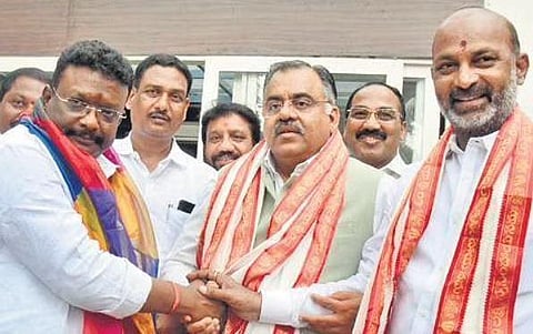 State BJP president Bandi Sanjay is all smiles as Tarun Chugh welcomes Dasoju Sravan into the partyfold