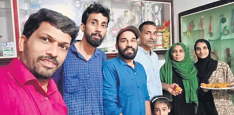 Abdulla’s family celebrates his silver medal at his house on Sunday