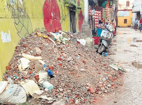 Construction waste dumped at the roadside near Bhakta Madhu Bidyapitha | Express