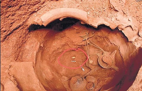 The burial urn in which the diadem (right) was found, along with several bronze and iron objects | Express