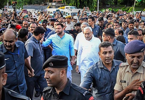 JD(U) leader Nitish Kumar and RJD leader Tejashwi Yadav leave after meeting Bihar Governor Phagu Chauhan, in Patna, Tuesday, Aug. 9, 2022. (Photo | PTI)