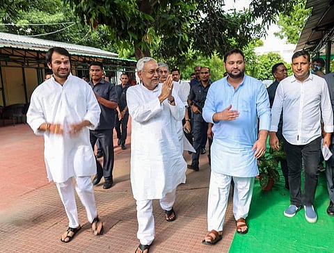Janata Dal (United) leader Nitish Kumar with Rashtriya Janata Dal leaders Tejashwi Yadav and Tej Pratap, in Patna, Tuesday, Aug. 9, 2022.  (Photo | PTI)