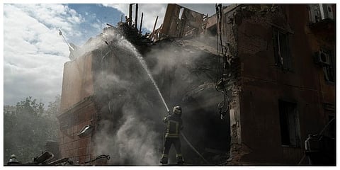 A firefighter works to extinguish a fire after a Russian attack that heavily damaged a residential building in Sloviansk, Ukraine. (Photo |AP)
