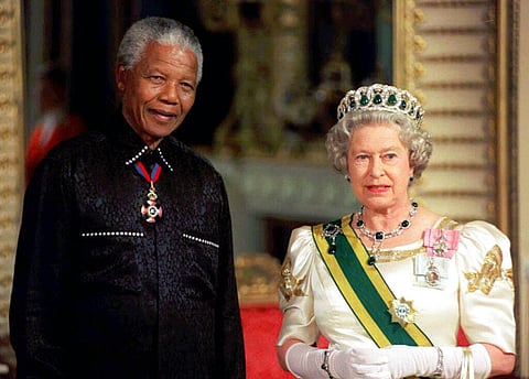 South African President Nelson Mandela stands with Britain Queen Elizabeth II on his arrival at Buckingham Palace, in London. (Photo | AP)