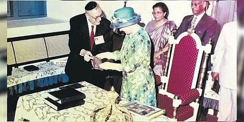 Queen Elizabeth II with Sammy Hallegua, Queenie’s husband, in 1997 | Express
