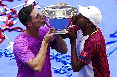 Joe Salisbury (Britain) and Rajeev Ram (United States) kiss the trophy after defeating Wesley Koolho (Netherlands) and Neal Skupski (Britain) in the final of the US Open tennis men's doubles champions