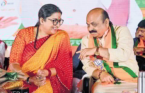 Chief Minister Basavaraj Bommai (right) shares a light moment with Union Minister for Women and Child Development and Minority Affairs Smriti Irani, at the Janaspandana programme in Doddaballapura on