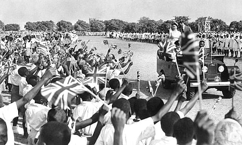 Thousands of flag-waving youngsters cheer as Queen Elizabeth II and the her husband Prince Philip, Duke of Edinburgh in Northern Nigeria. (Photo | AP)