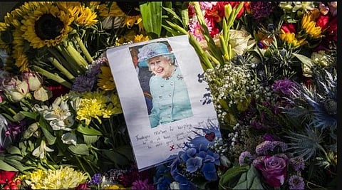 Floral tributes and a farewell message to Queen Elizabeth II are seen outside Holyrood Palace in Edinburgh, Scotland, Saturday . (Photo | AP)