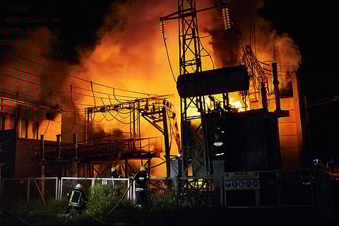 Ukrainian State Emergency Service firefighters put out the fire after a Russian rocket attack hit an electric power station in Kharkiv, Ukraine. (Photo | AP)