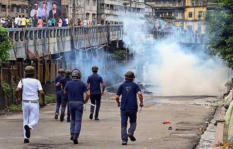 Security personnel use tear gas to disperse BJP supporters from the Howrah Bridge during their 'Nabanna Abhijan' (March to Secretariat). (Photo | PTI)