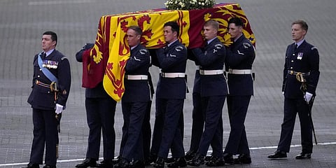 The coffin of Queen Elizabeth II is carried off a plane by the Queen's Colour Squadron at RAF Northolt in London, to be taken to Buckingham Palace.(Photo | AP)