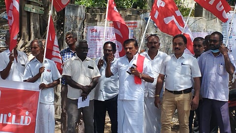 The members of All India Trade Union Congress (AITUC) demonstrating in front of the LIC office on beach road in Thoothukudi. | Express