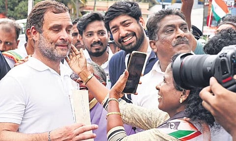 Congress loyalist D Suma, a native of Vattappara, makes Rahul Gandhi pose for a photograph during the Bharat Jodo Yatra at Mamom in Attingal on Tuesday. | BP Deepu