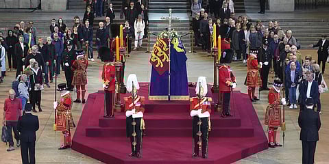 Members of the public pay their respects as they walk past the coffin of Queen Elizabeth II.(Photo | AP)