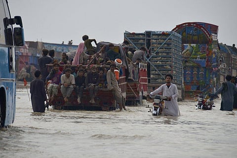 Displaced Pakistani families from flood hit areas board vehicles while they move to safe place, in Nasirabad, a district of Pakistan's southwestern Baluchistan province (Photo | AP)