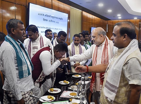 Union Home Minister Amit Shah being greeted by representatives of eight tribal militant organisations based in Assam (Photo | PTI)