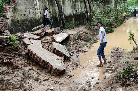 Debris lie on the ground after the boundary wall of an Army enclave collapsed due to heavy overnight rains, in Lucknow (Photo | PTI)