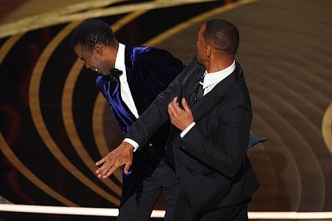 Will Smith (R)  hits Chris Rock at the 2022 Oscars. (File Photo | AP)