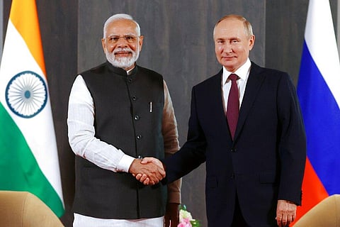 Russian President Vladimir Putin, right, and Indian Prime Minister Narendra Modi pose for a photo shaking hands prior to their talks. (Photo | AP)