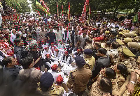 Samajwadi Party President Akhilesh Yadav with party workers after being stopped during their march towards UP Vidhan Bhavan in Lucknow. Monday. (Photo | PTI)