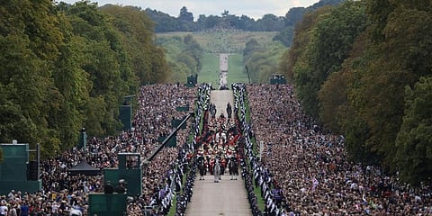 The hearse travels along the Long Walk as it makes its way to Windsor Castle, on the day of the state funeral and burial of Britain's Queen Elizabeth, in Windsor. (Photo | AP)