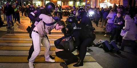 Riot police detain demonstrators during a protest against mobilization in Moscow, Russia. (Photo |AP)