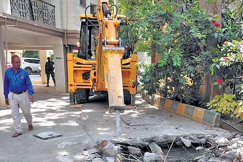 A BBMP bulldozer at work at the Greenwood Regency on Wednesday | Express