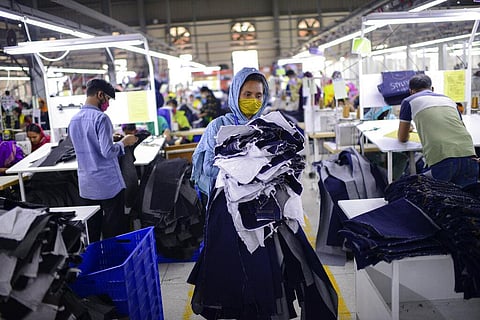 Garment factory employees work at Arrival Fashion Ltd. in Gazipur, Bangladesh, Saturday, March 13, 2021.  (File photo | AP)