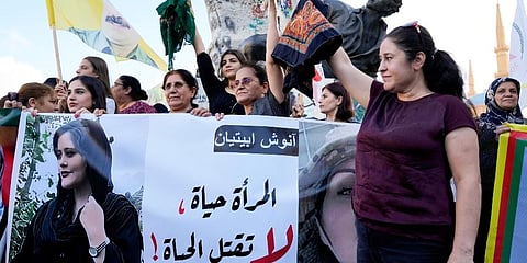 Kurdish women activists hold headscarfs and a portrait of Iranian woman Mahsa Amini. (Photo |AP)