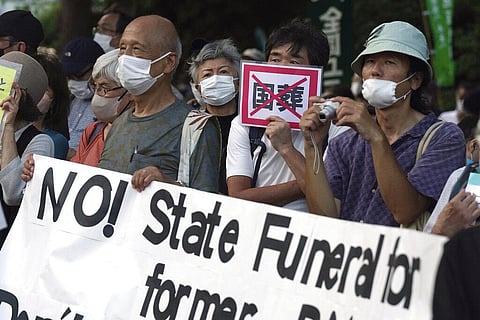 People protest outside Diet against the state paying for Japan's former Prime Minister Shinzo Abe's funeral in Tokyo. (File Photo | AP)
