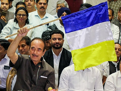 Former Jammu and Kashmir chief minister Ghulam Nabi Azad unveils the flag of his new 'Democratic Azad Party' during a press conference, in Jammu on Monday. (Photo | PTI)